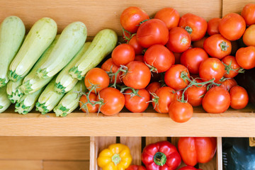 Fresh a variety of vegetables lie on the counter in the store, supermarket or vegan coffee shop. Purchase of tomatoes, zucchini, sweet pepper, vegetables variety.