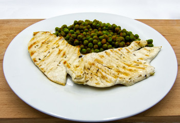 Grilled chicken breasts with peas in tomatoes sauce