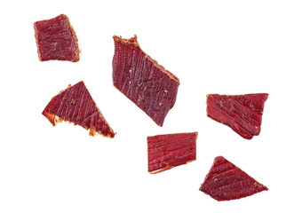 Beef jerky on a white white background, top view.