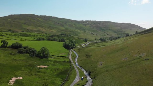 Flying into the Barbon Beck Valley, Carnforth, Lancashire, whilst descending slowly. This stunning countryside features a stream running alongside a small country lane.