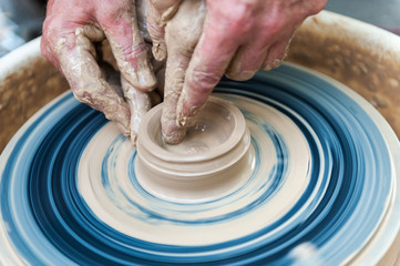 Handcrafted, Hands make clay. Master teaches the student to make pitcher on pottery wheel.
