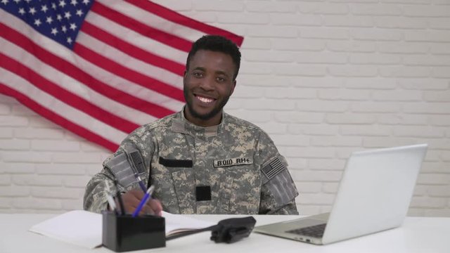 Happy afro-american officer during working process in office