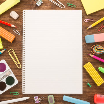   School supplies on wooden background 