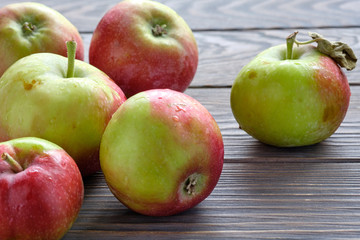 fresh harvest apples on brown natural old wooden table surface.
