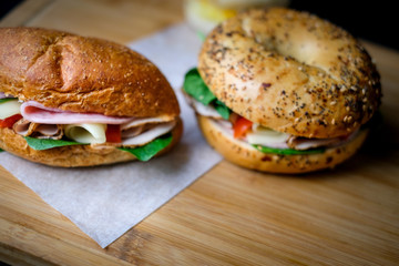 Delicious classic blt sandwiches with ham, cheese, bacon, tomatoes. Breakfast and fast food meal. on isolated black background wooden and text copy space.