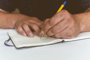 a person makes an entry in a notebook for doing business