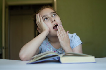 child reading a book at the table