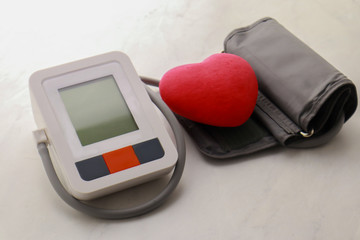 Tonometer and decorative heart on light background
