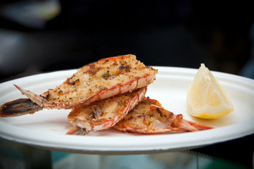Breaded shrimps with lemon on a plate