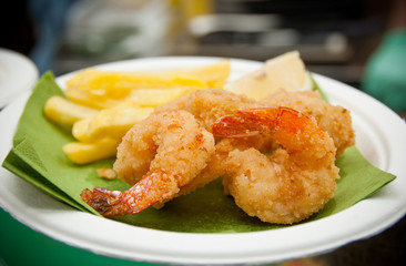 Breaded shrimps and french fries on a plate