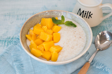 Oatmeal bowl with mango for Breakfast