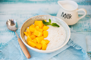 Oatmeal bowl with mango for Breakfast