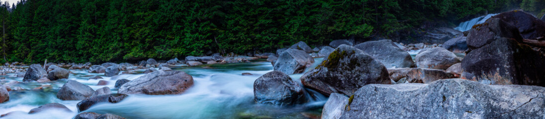 Flowing water from waterfall along the rocks at dusk