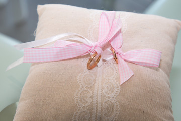 gold wedding rings on the cushion