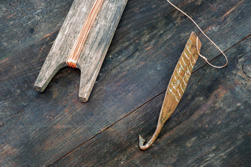 Ancient tackle for vertical flashing predatory fish. Copper forged spinner and reel with rope on...