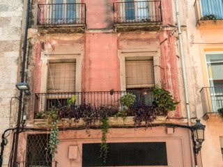 Fototapeta na wymiar Old building with balconies damaged with time