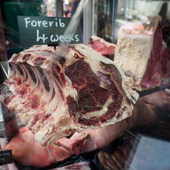 Aged Forerib steak in a Butcher shop in Borough Market. London, 2017. Squared format.