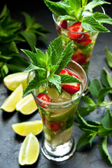 Citrus fruit cocktail with   mint, lime and strawberry  in glass