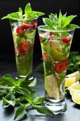 Citrus fruit cocktail with   mint, lime and strawberry  in glass