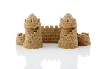 Sandcastle at the beach isolated over white