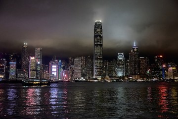 Fototapeta premium 07 03 2019 China, Hong Kong city, Victoria harbour - skyline with skyscrapers in the night, cloudy sky