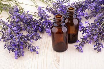Fototapeta na wymiar essential oil and lavender flowers on wooden table
