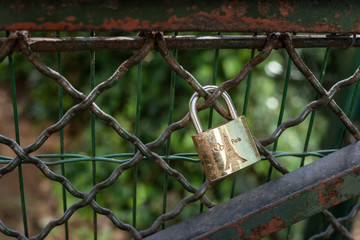 Love-lock with two hearts and Eiffel Tower on a rusty fence in Paris France