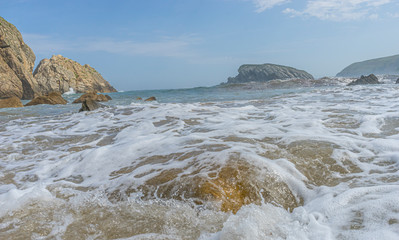 Fototapeta na wymiar Cantabrian coastline landscape in costa quebrada, Arnia Beach, Coast of Liencres Cantabria, Spain