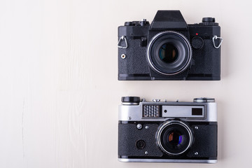 Fototapeta premium Old vintage retro two photo film camera copy space top view flat lay on white background