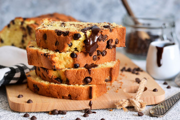 Vanilla bread with chocolate drops on the kitchen table. Slices of cake.