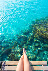 Ibiza girl legs at Portinatx beach clear water