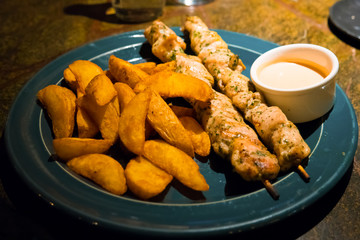 Chicken skewer, potatoes and sauce