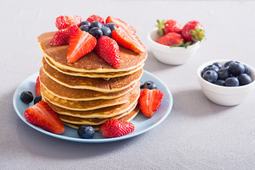Tasty pancakes with blueberry and strawberry