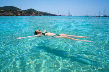 Ibiza bikini girl swimming clear water beach