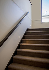 Modern carpeted staircase with night lighting