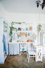Stylish and sunny interior of kitchen space with small wooden table at the photo studio....