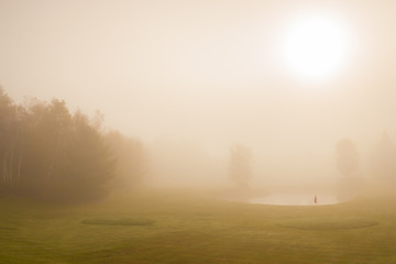 Naklejka na ściany i meble Early morning fog on a golf course, Stowe Vermont, USA
