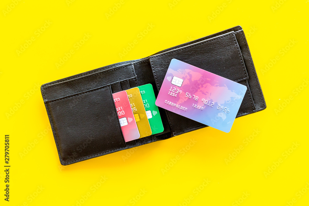 Wall mural business with credit cards and wallet on office desk yellow background top view