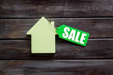 Sale for house with lable and figure on wooden background top view