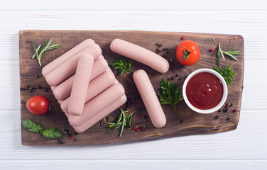 Raw beef sausages with pepper , herbs and ketchup