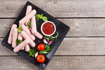 Raw beef sausages with pepper , herbs and ketchup