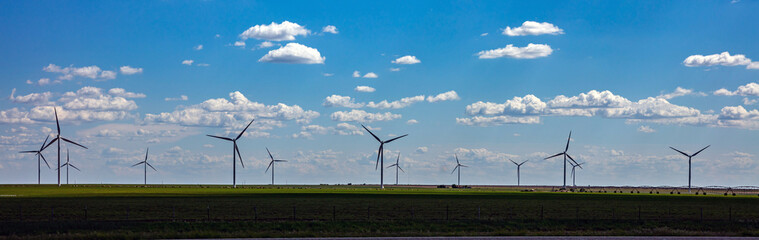 Wind turbines, renewable energy on a green field, spring day. Wind farm, West Texas, USA.