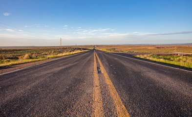 Long highway in the american desert, blue sky