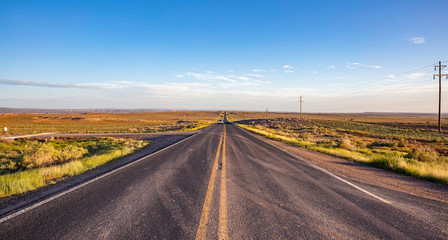 Long highway in the american desert, blue sky