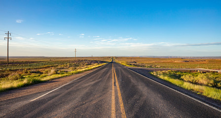 Long highway in the american desert, blue sky