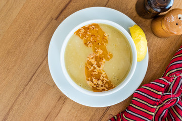 Turkish Lentil Soup with fried butter sauce / Mercimek Corbasi at Restaurant.