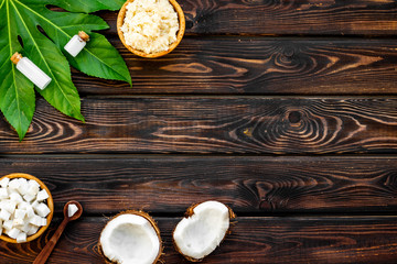 Homemade organic cosmetics with coconut on wooden background top view mock up