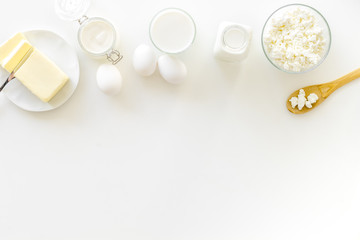 Fresh dairy products for breakfast with milk, cottage, eggs, butter, yougurt on white background top view mock up
