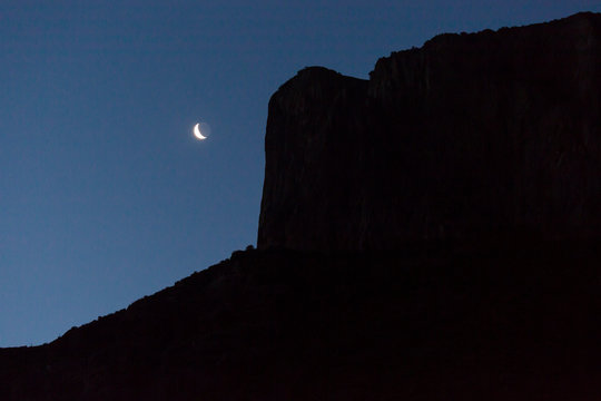 Beautiful landscape view of the moon rising over the Chisos Basin in Big Ben National Park in Texas.
