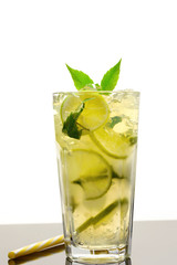 Cooling lemonade with lemon and lime, slices of ginger and mint leaves.